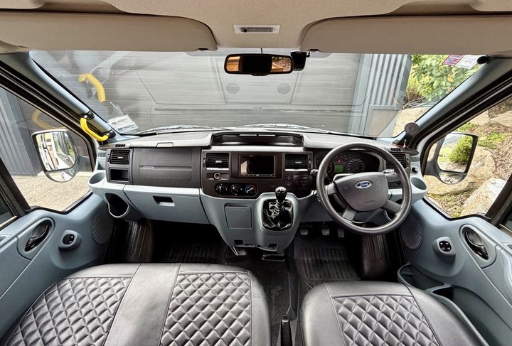 Transit dashboard with the CarPlay head unit, gearshift and quilted seat covers
