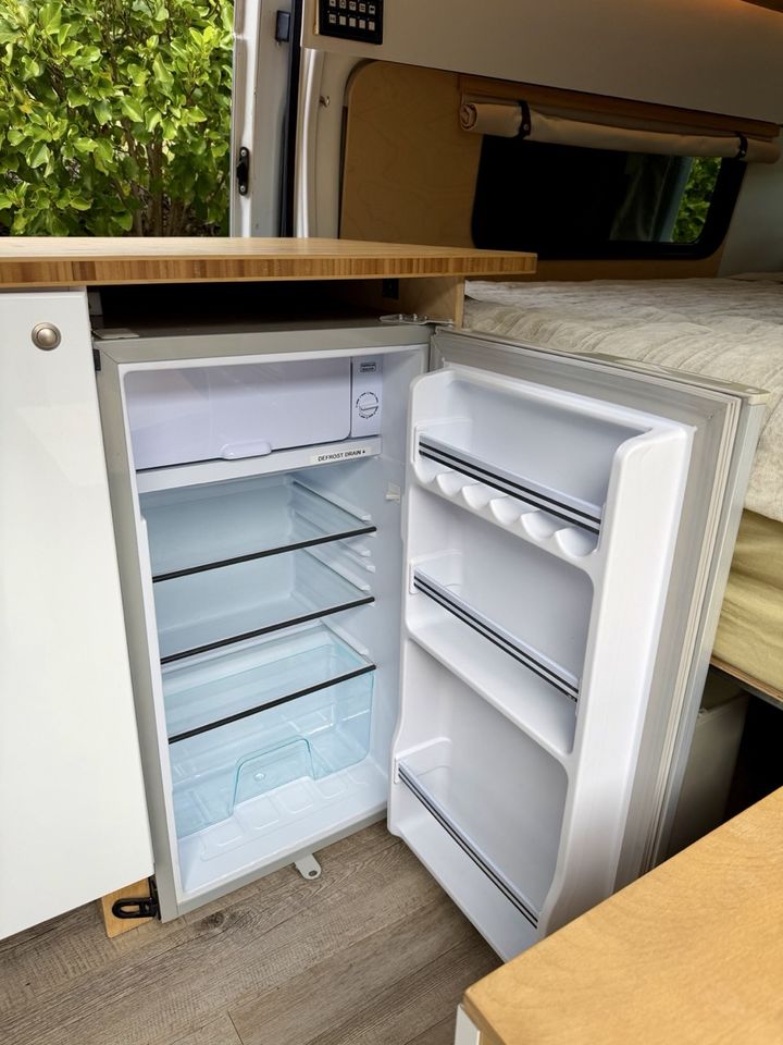 The 90 litre 12V fridge freezer with the door open and shelves empty